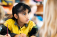 Child sitting at a desk holding a pencil.